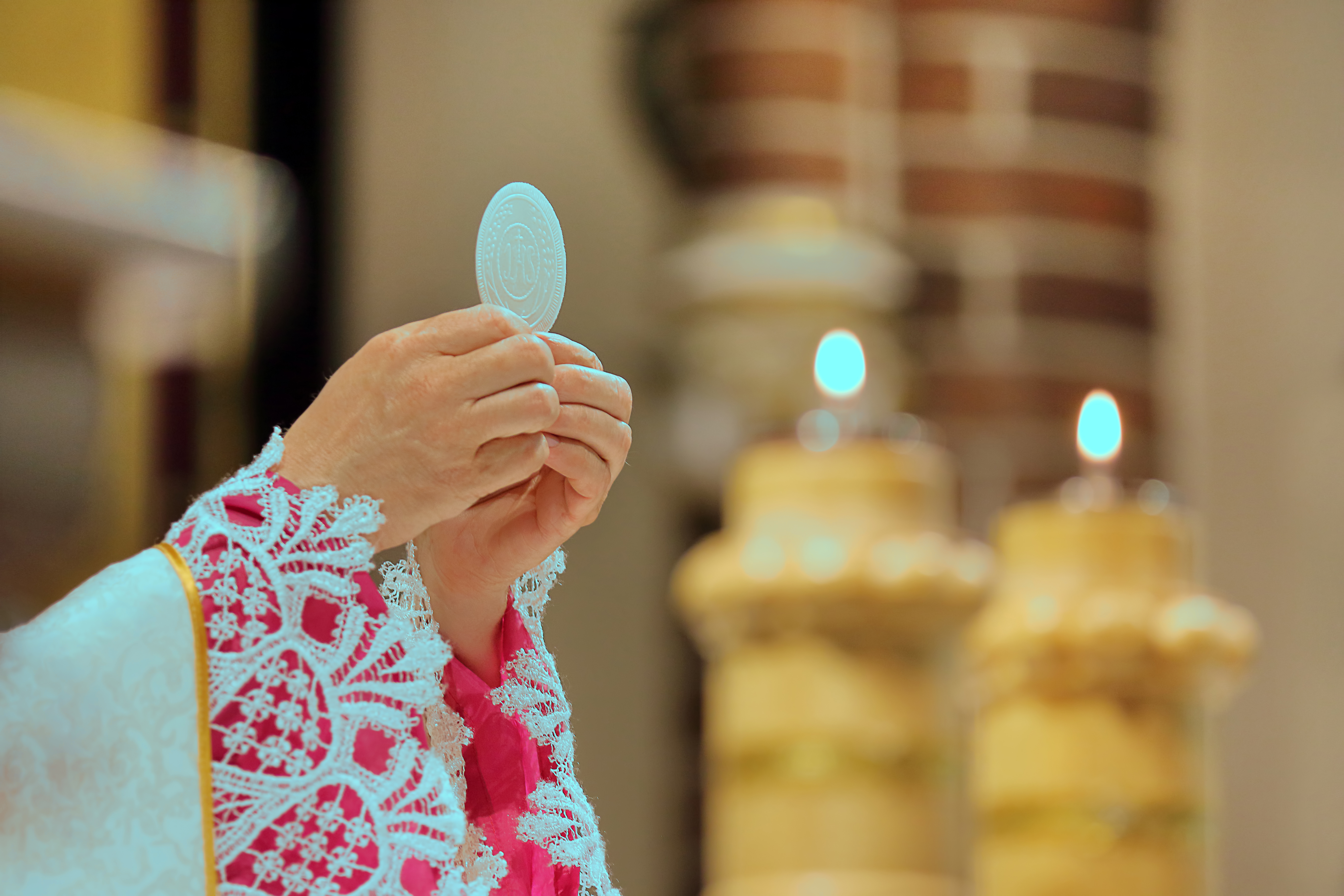 A Communion wafer held during the Eucharist.