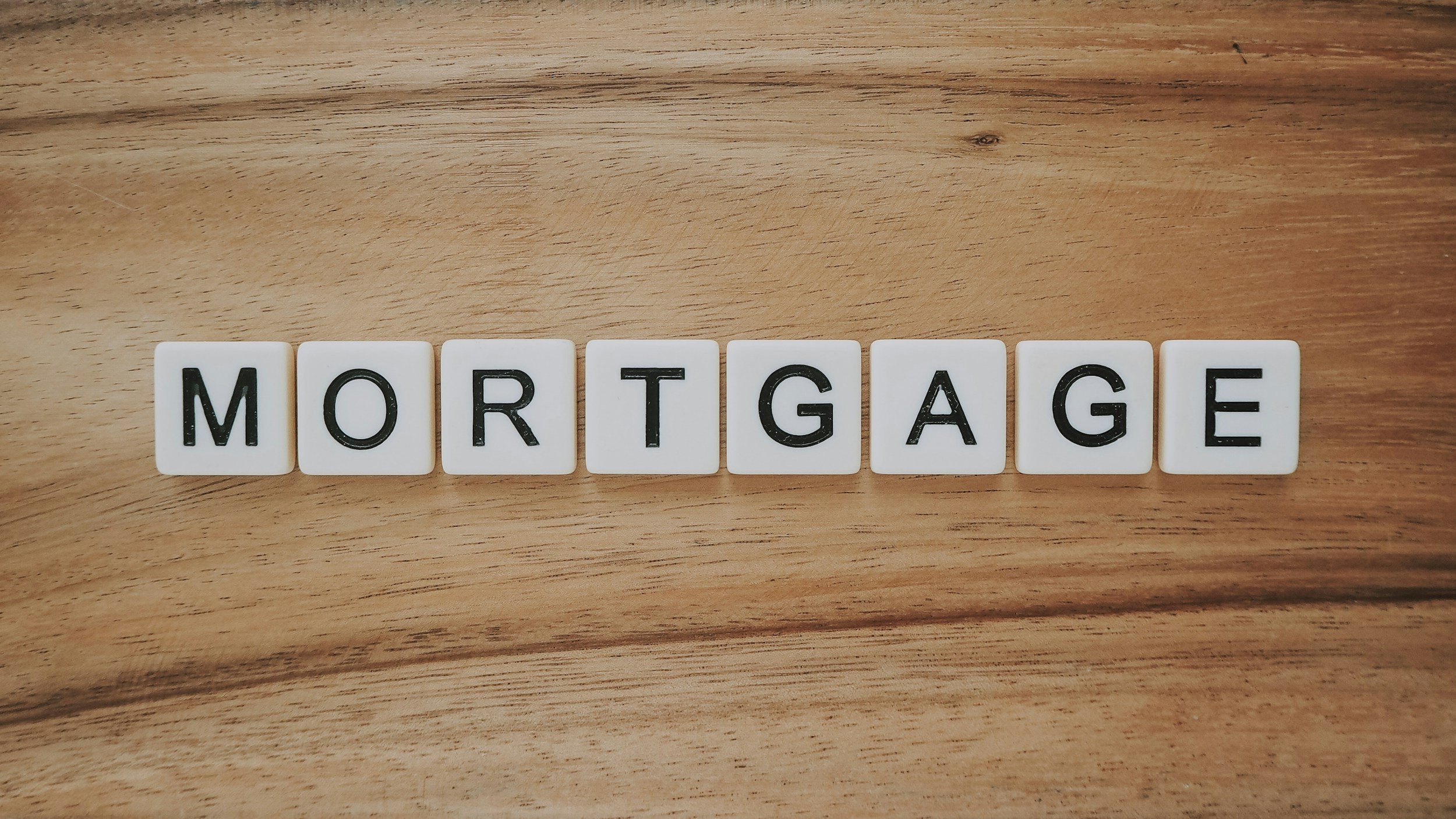 Letter tiles spelling “mortgage,” illustrating the parish’s mortgage payoff.