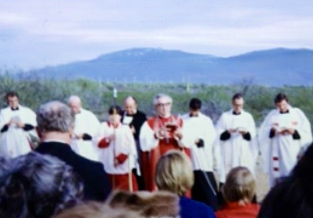 Clergy and parishioners gathered outdoors for the church groundbreaking.